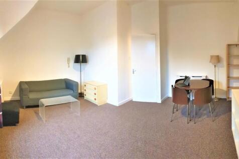 Bright and spacious living area with dining set...
