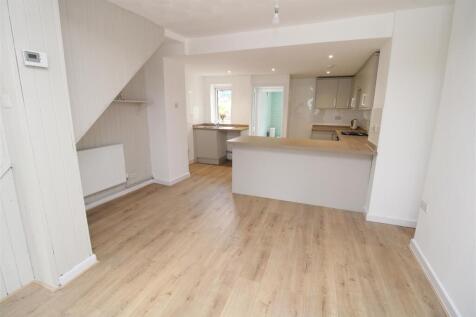 Bright open-plan living with sleek wood floorin...