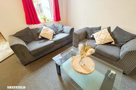 Bright, cosy living room with two comfortable g...
