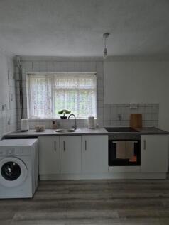 Fitted kitchen with washing machine and window...