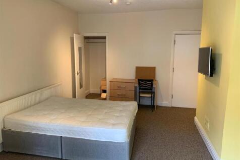 Bright, neutrally decorated double bedroom with...