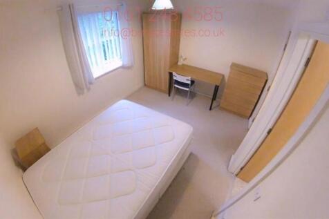 Bright, simply furnished bedroom with a double ...