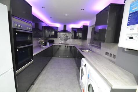 Modern galley kitchen with sleek grey cabinetry...