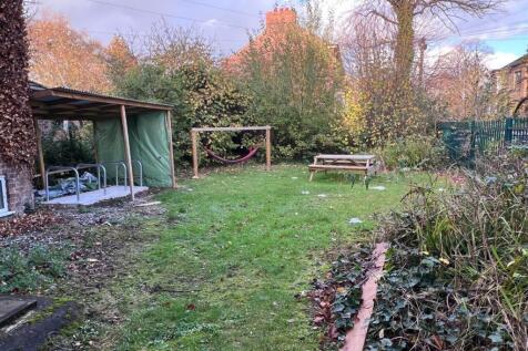 Spacious green garden with picnic bench...