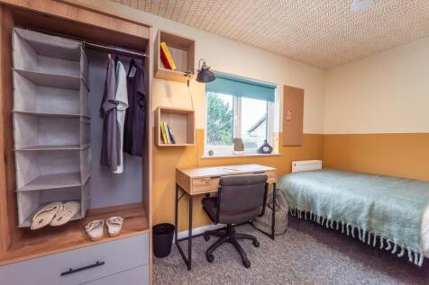Bright modern bedroom with stylish study desk a...