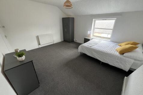 Bright and spacious double bedroom featuring a ...