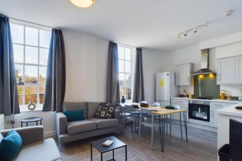 A bright and modern kitchenette with ample seat...