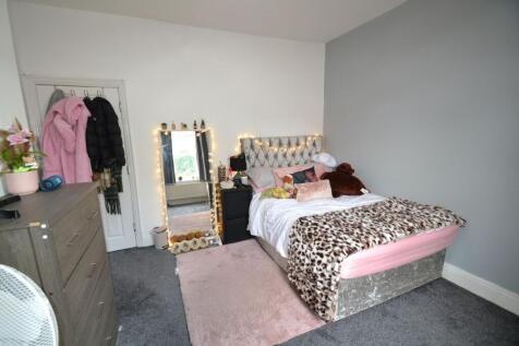 Cozy and stylish bedroom featuring a comfortabl...