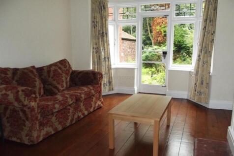 Bright living room with large windows and sofa...