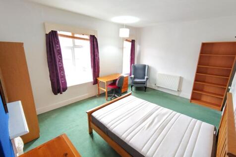 Spacious bedroom with ample storage and desk...