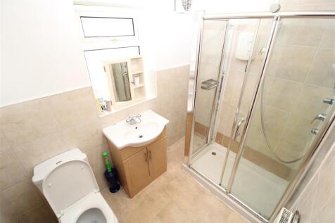 Bright bathroom with modern glass shower cubicl...