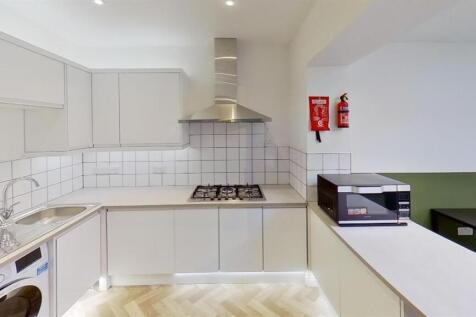 Bright modern kitchen with sleek white cabinets...