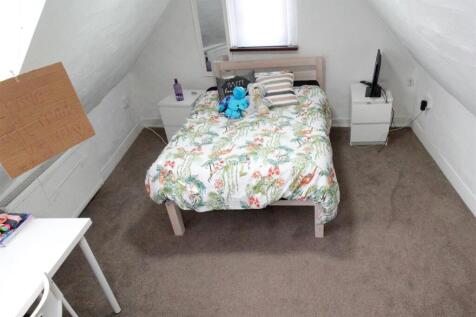Cozy attic double bedroom with bed and bedside ...