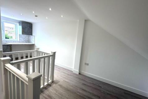 Bright first-floor landing with modern wood-eff...