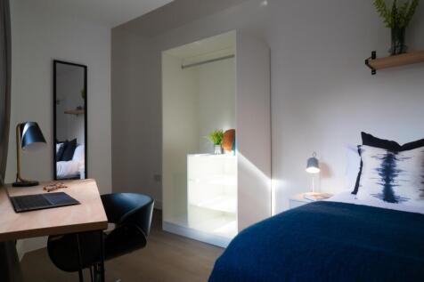 This inviting double bedroom features a cozy be...