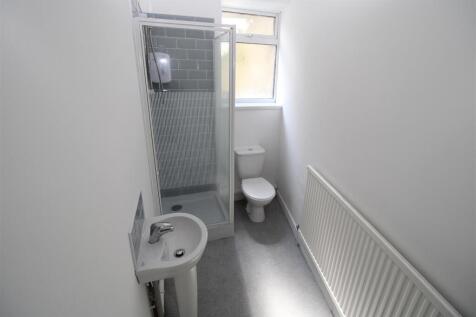 Bright modern shower room with sleek tiling...
