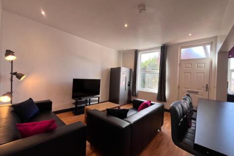 A modern and cozy living room featuring comfort...