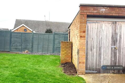 Garage With Adjacent Brick Barbecue 