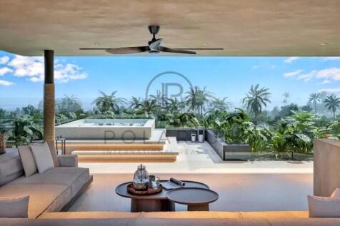 A luxurious open-air living space with a ceiling f