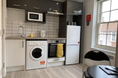 Modern kitchen with sleek units and natural lig...