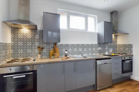 A modern and stylish kitchen with ample space a...