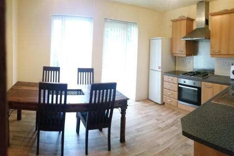 Bright kitchen with dining area featuring a woo...