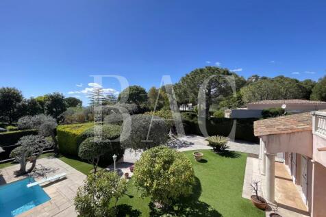 A luxurious villa with a swimming pool is surround