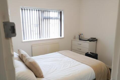 Bright bedroom with double bed and storage...