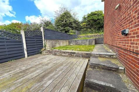 Spacious multi-level garden with wooden decking...
