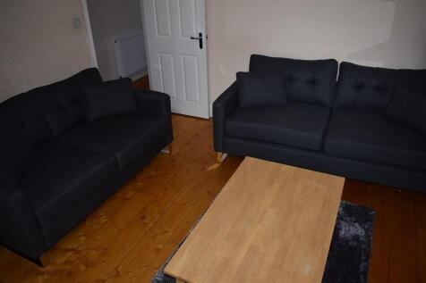 Bright, modern living room with two matching so...