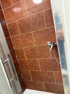 Stylish tiled shower area with modern fixtures...