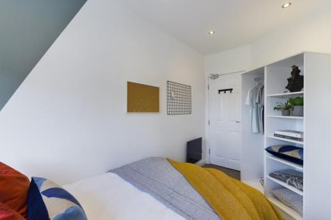 A bright and inviting double bedroom featuring ...