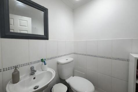 Neat white bathroom with sink and toilet...