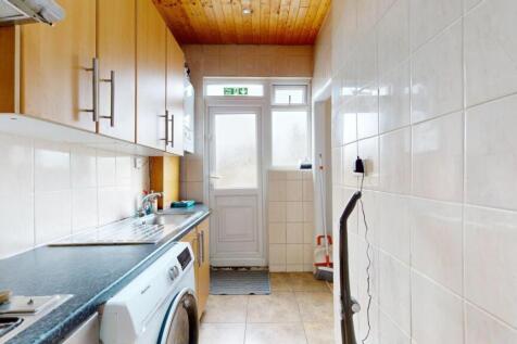 Bright galley kitchen with ample upper cabinetr...