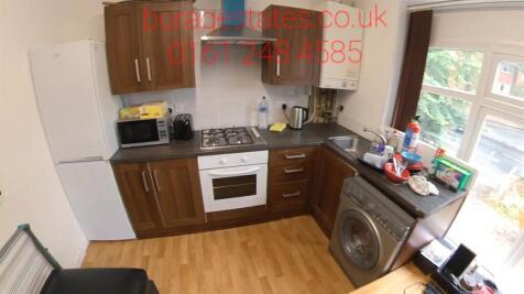 Bright fitted kitchen with wood-style cabinets,...