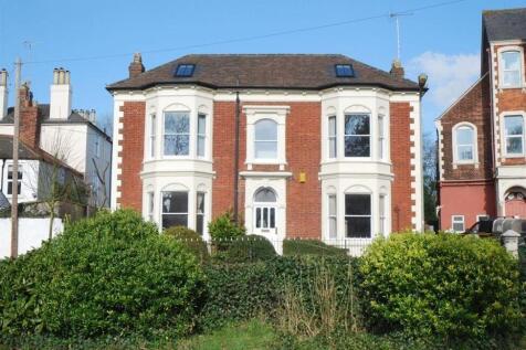 Grand red brick house with lovely bay windows...