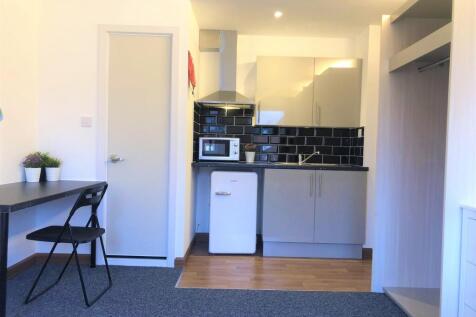 Bright and modern kitchenette featuring sleek c...