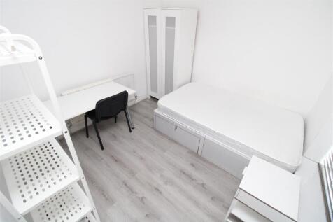 Bright modern bedroom with sleek white finishes...