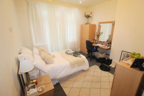 A bright and welcoming master bedroom featuring...