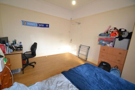 Bright, neatly presented bedroom with wood floo...