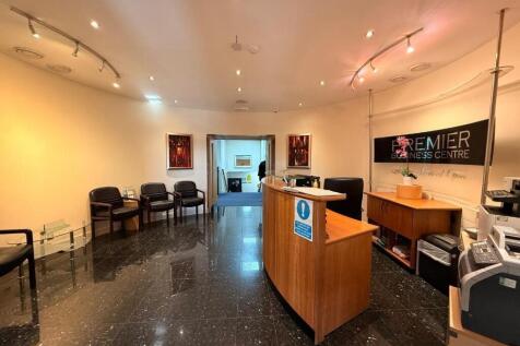 Bright, modern reception area with a staffed de...