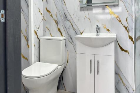 Bright, modern bathroom with a sleek white toil...