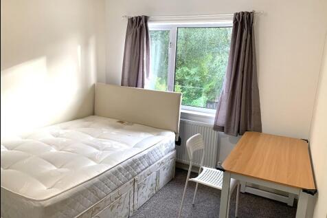 A clean and bright single bedroom featuring a c...