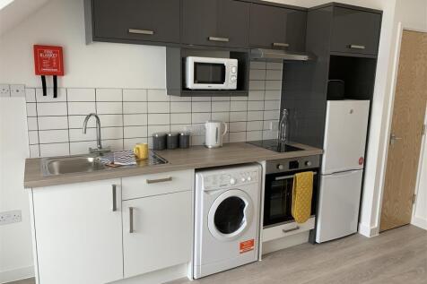 Modern integrated kitchen with sleek cabinetry...