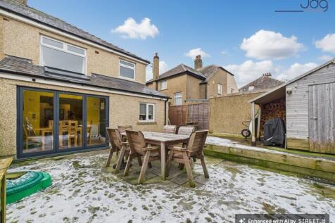 Landscaped East facing rear garden offering privacy, patio seating, and useful storage