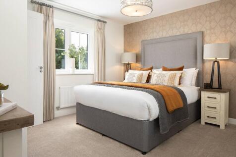 A spacious main bedroom has plenty of room for a wardrobe