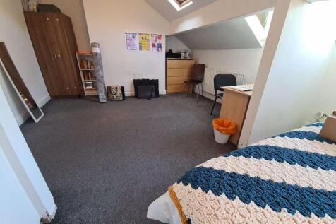 A spacious, well-lit living room featuring comf...
