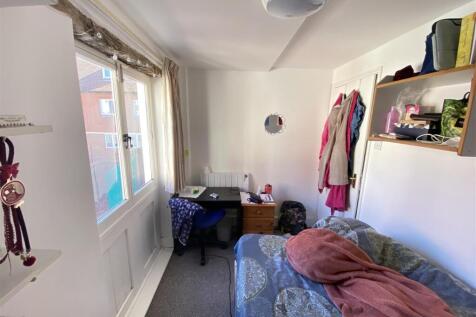 Bright bedroom with desk and natural light...