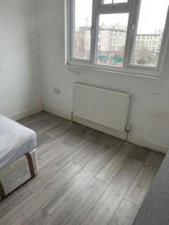 Bright bedroom with stylish wood-effect floorin...