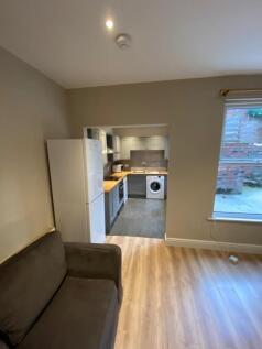 Bright, open-plan living area with wood-effect ...